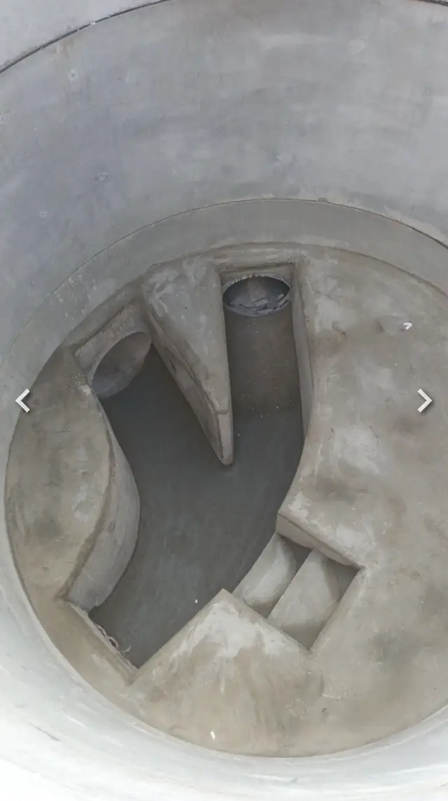 Looking down into a newly built drainage inspection chamber
