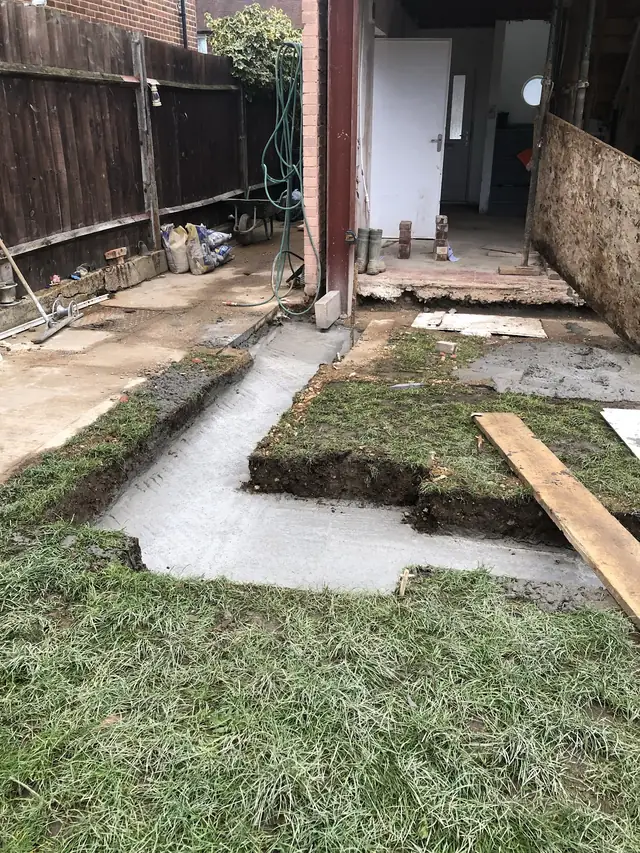 Concrete footings poured at the back of a house ready for an extension