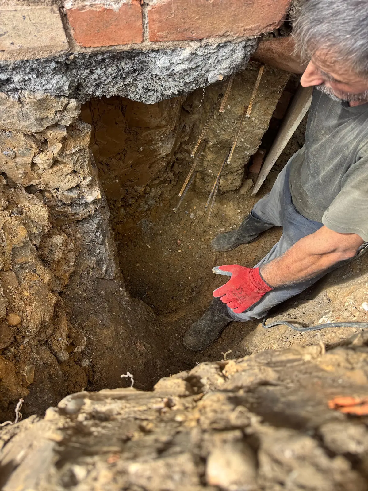 Underpinning pit dug beneath the footing of a brick wall